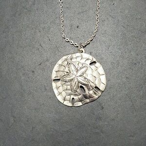 Silver tone sand dollar pendant necklace